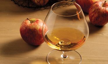 Whisky tasting glass near to an apple