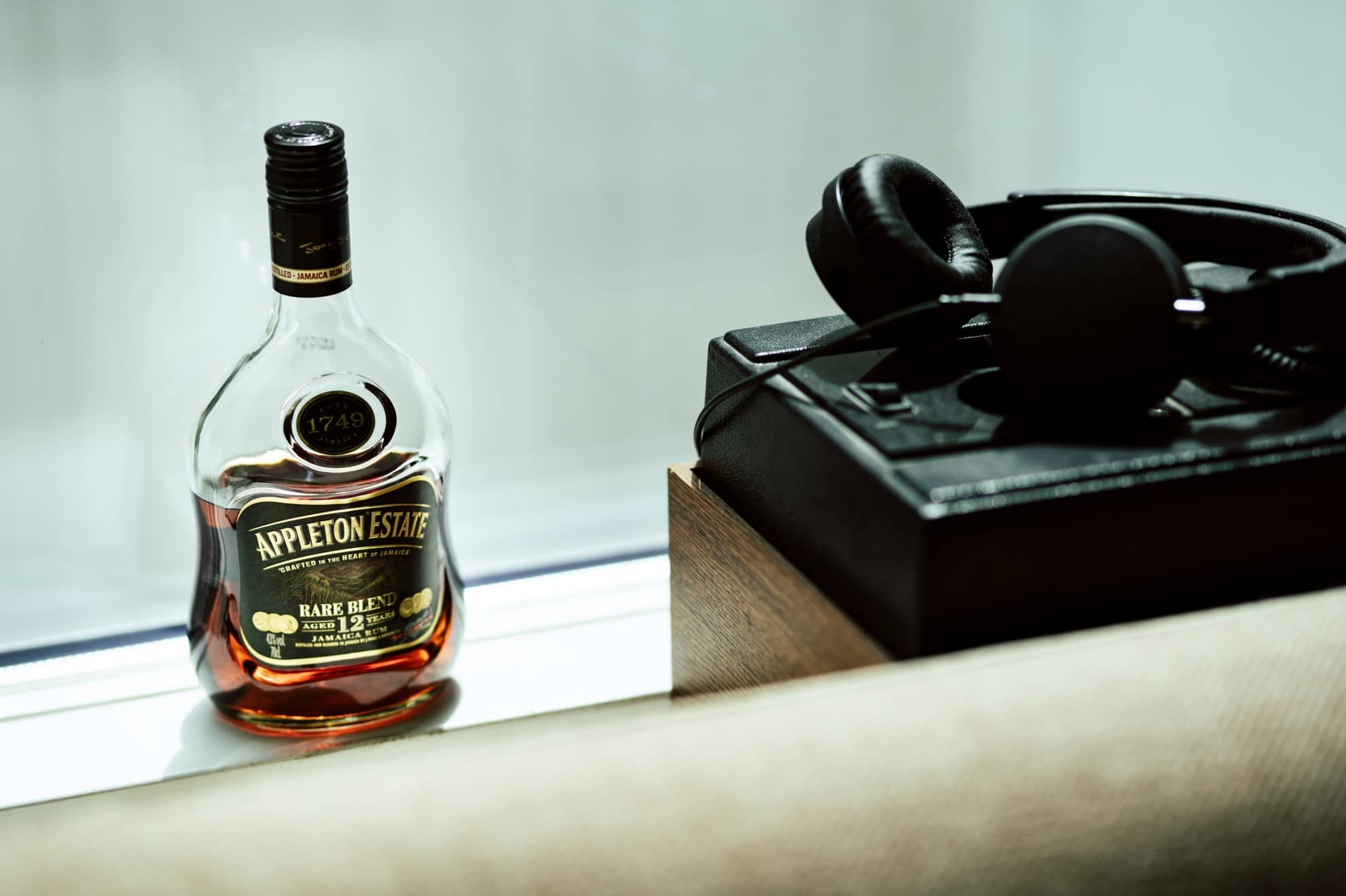 A rare whisky next to headphones