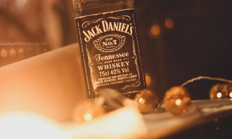 Bottle of jack daniel's whiskey surrounded by lights