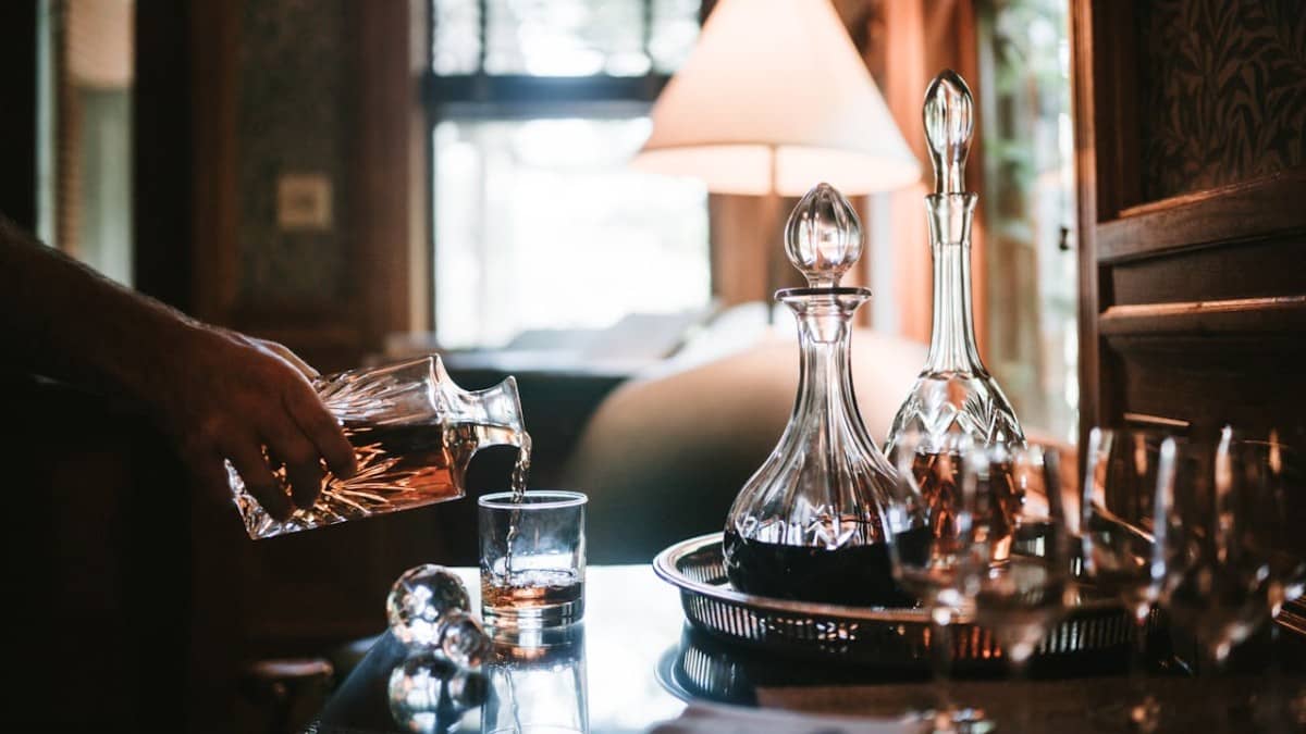 Three decanter with three diferent drinks: whiskey, brandy and rum.
